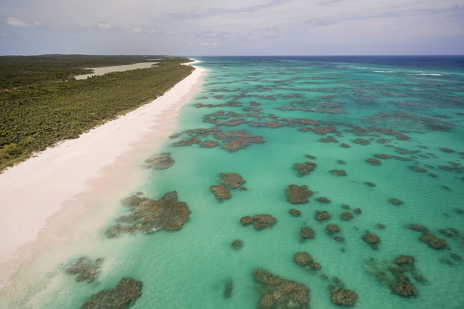 Pink-tinged sand and reef along the Atlantic shore of Cat Island